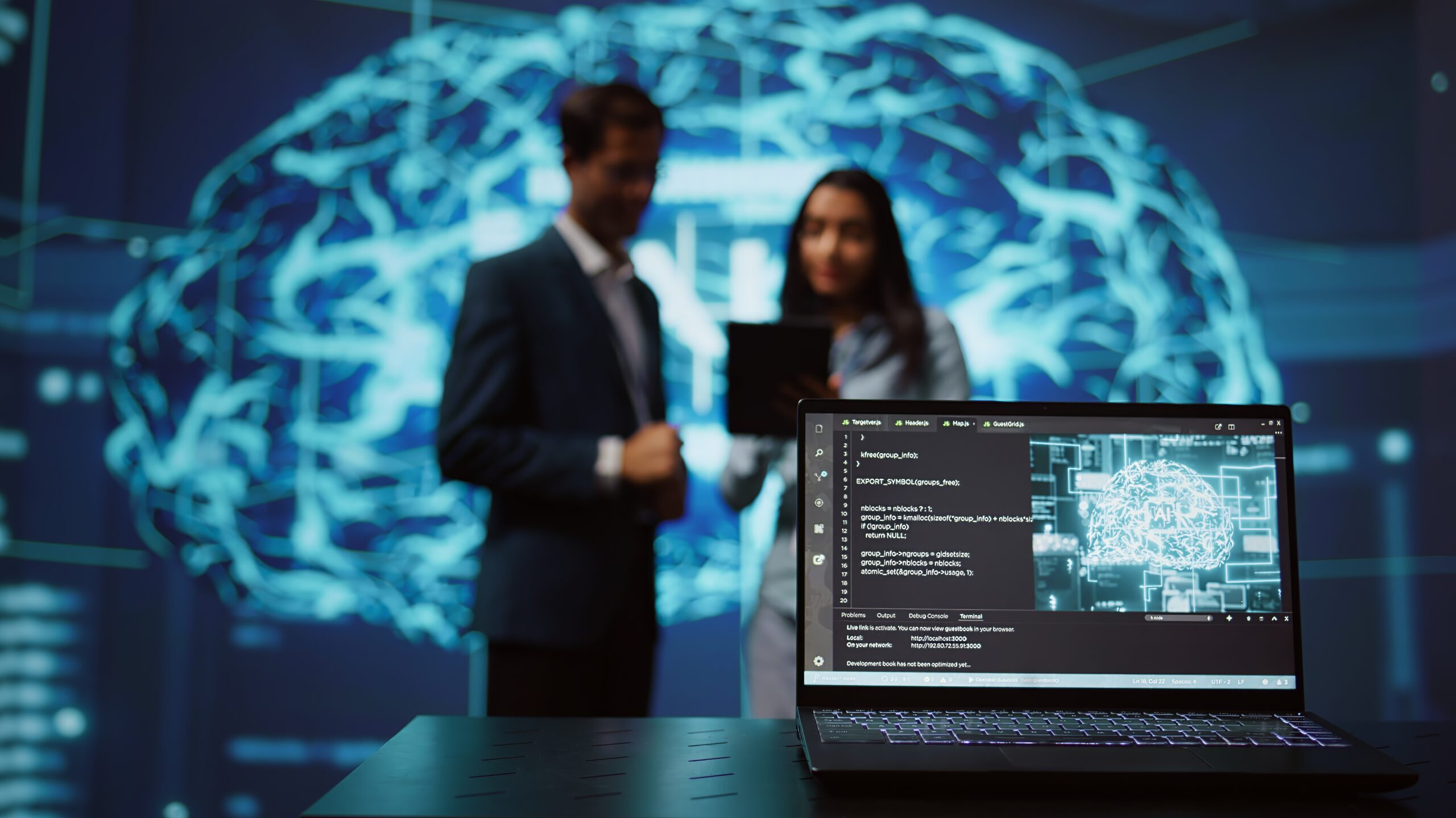 Focus on laptop in workspace used by AI researchers working with artificial intelligence in blurry background. Close up of notebook used by employees developing AI systems in tech startup
